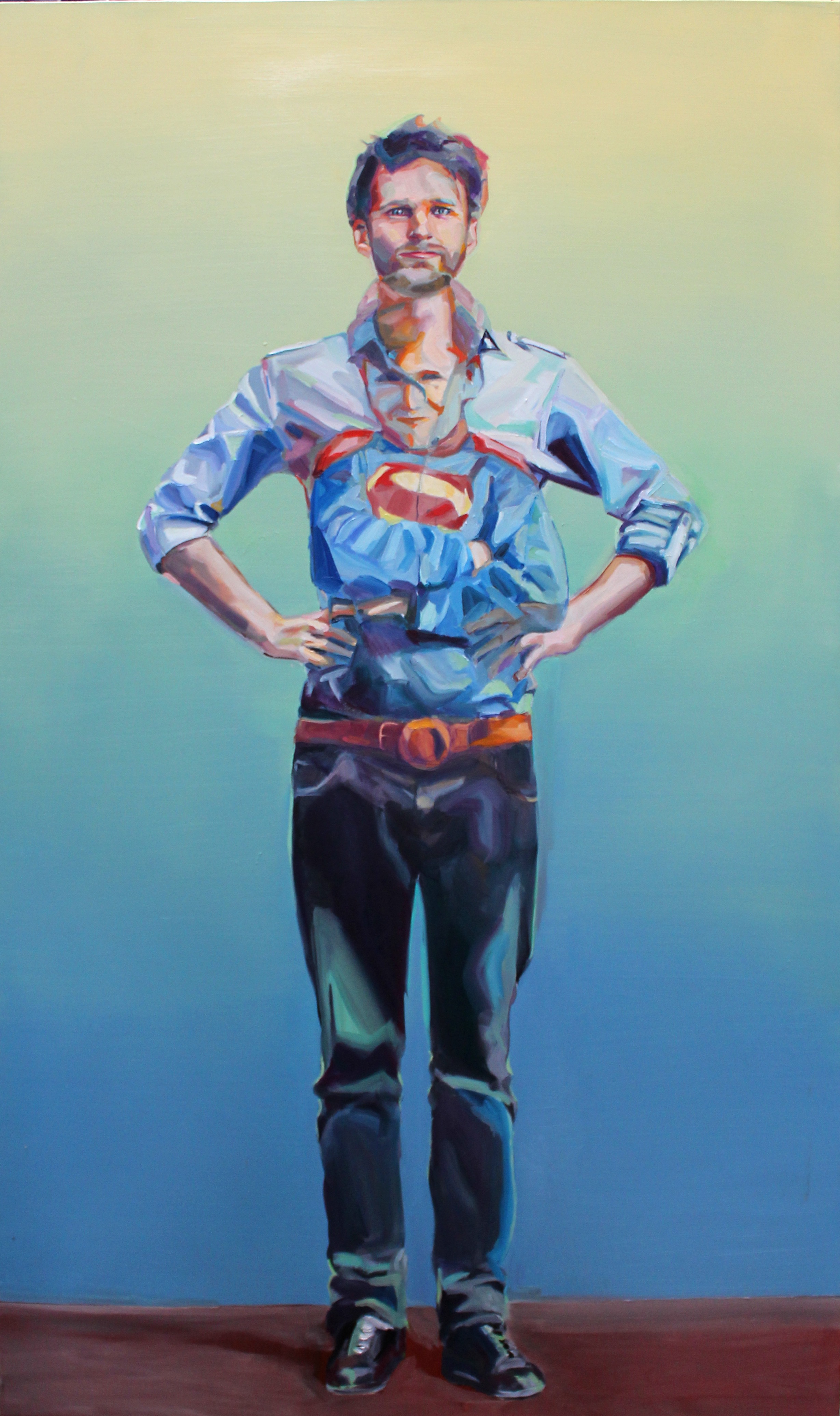 Full-length oil portrait of a man in a Superman T-shirt and open blue shirt standing against a graduated green field.